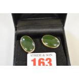 A pair of oval jade earrings. hallmarked 375.