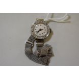 An 18ct white gold and diamond set ladies wristwatch, London 1926, on a 9ct gold mesh bracelet,