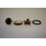 Three various gem set gold rings, stamped 375; together with an unmarked eternity ring.