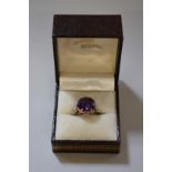 An amethyst gold ring stamped 14k.