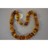 A chunky amber piece necklace, 56cm, 83g.