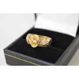 A chased buckle gold ring,Â hallmarked 18ct, 4.9g.
