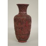 A Chinese cinnabar lacquer vase, probably early Qing, decorated in relief with figures in a