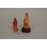 Two Chinese agate or red jade figures, comprising: a sage, 9cm high, on fitted hardwood stand; and