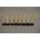 A set of eight Chinese carved ivory sages, 10.5cm high, each on wood stand.