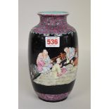 A Chinese famille rose black ground vase, Qianlong four character mark, painted with five boys, 20.