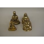 A Tibetan brass Buddha, 9.5cm high; together with a Chinese brass figure of a kneeling official,