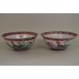 A matched pair of Chinese famille rose phoenix bowls,Â Qianlong seal marks,Â 20cm diameter, (2).