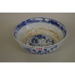 A Chinese blue and white bowl, Kangxi four character mark, painted with a continuous landscape, 23.