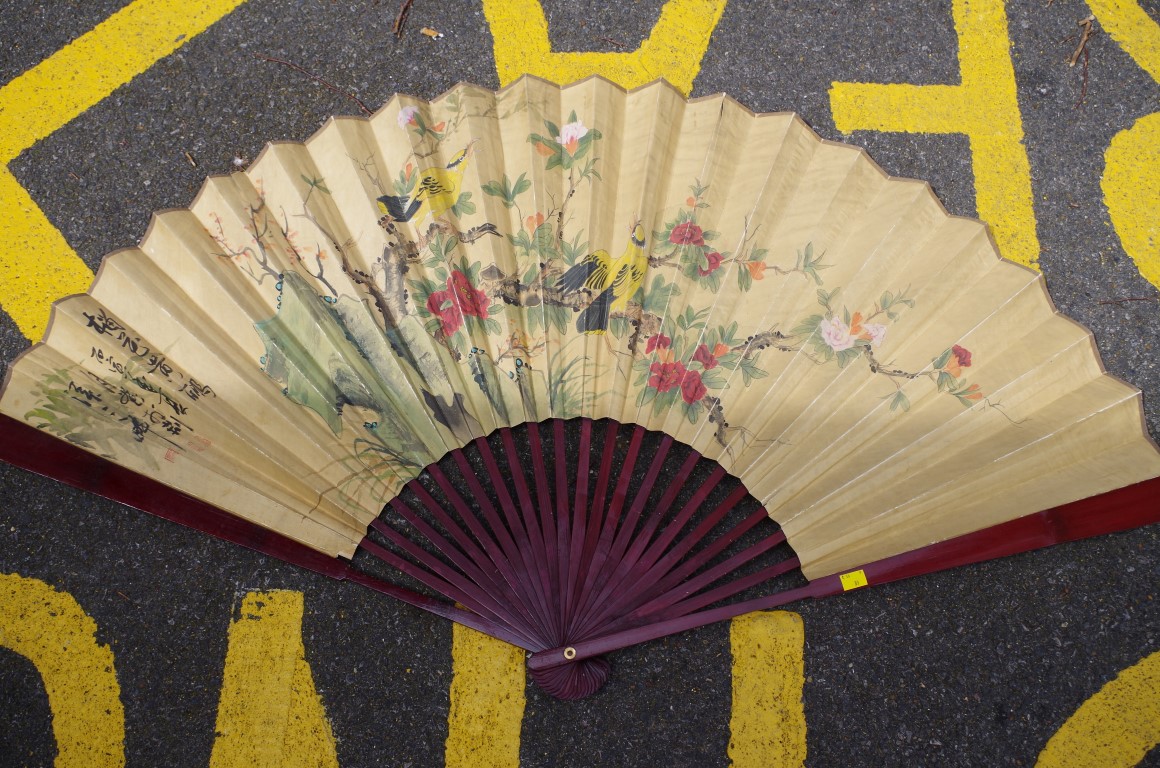 A large Chinese watercolour painted fan, decorated with birds in a landscape, signed, the guards,