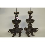 A pair of Chinese bronze lion dog pricket candlesticks, probably late Qing, 47cm high.