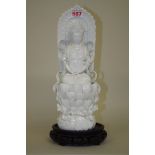 A Chinese blanc de chine figure of Guanyin, 30.5cm high, on wood stand.