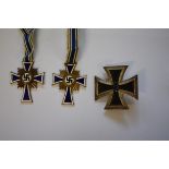 Two World War II German enamel Mother's medals; and an Iron Cross 1st Class.