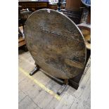 An old oak circular tilt top table, 98cm diameter.
