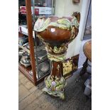 A majolica jardiniere and pedestal, the underside of the jardiniere inscribed 'Vulcan', 109cm high.