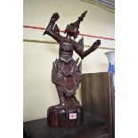 A pair of Burmese carved wood dancing figures, 58cm high.