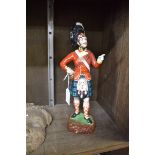 A Dresden porcelain figure of a Highland soldier, 28cm high.