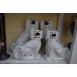 Two pairs of Victorian Staffordshire spaniels, largest 34cm high.