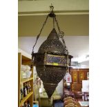 A Moroccan pierced brass and stained glass lantern, 50cm high.