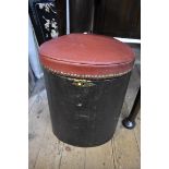 An unusual leather stool with studded red hinged top.
