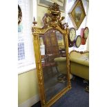 A large and impressive 19th century Continental gilt framed overmantel mirror, with cherub and urn