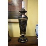 A black and gilt pottery table lamp, converted.