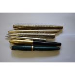 Two silver propelling pencils; together with another silver ballpoint pen; and three vintage