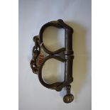 A pair of vintage Hiatt steel handcuffs, with key.