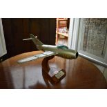 A Breitling MiG-15 fighter jet window display model, on walnut base, 36.5cm wingspan.