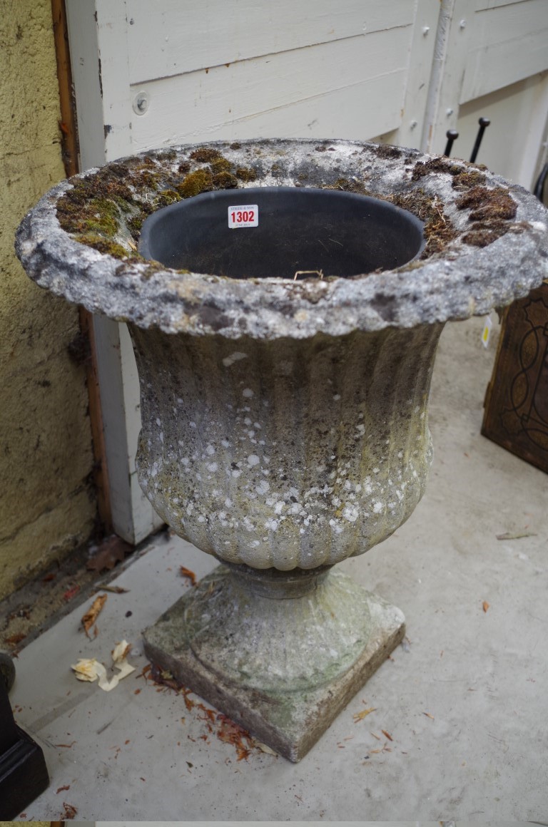 An old weathered composition stone campana urn, 59cm high.