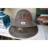 Two World War II tin helmets.