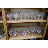 A collection of English drinking glasses, to include examples by Stuart. (two shelves)