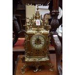 A brass mantel clock, 50cm high, with pendulum.