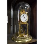 A brass anniversary clock, with glass dome, total height 33cm.