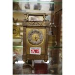 An old brass carriage timepiece, height including handle 15.5cm.