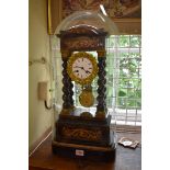 A late 19th century ebonized and inlaid portico clock, 46.5cm high, with pendulum, on ebonized stand