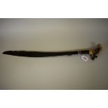 A Borneo Mandau Dayak headhunter’s sword, having 52cm engraved iron blade and ornately carved antler