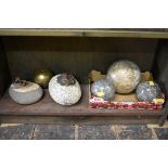 Three marble spheres, largest 14cm diameter; together with two old stone livestock tethers; and