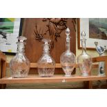 Two pairs of clear glass decanters and stoppers.
