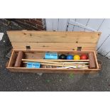 An old croquet set, in pine box; together with two pairs of petanque balls.