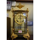 A brass and gilt metal mounted four glass mantel clock, by Ansonia, 38cm high, with mercury