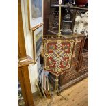 A Victorian brass tripod pole screen, with gros point and beadwork panel.