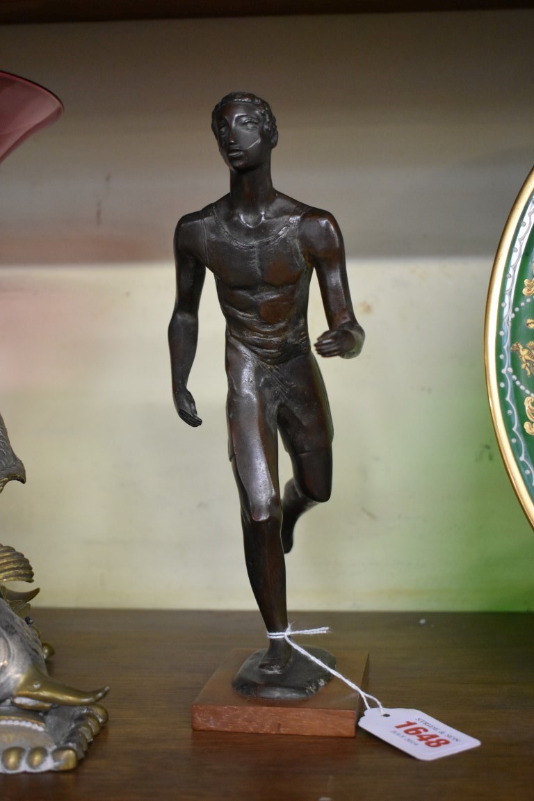 Willi Soukop, a bronze figure of a runner, initialled, on walnut base, further inscribed 'Soukop' to