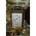 An old brass carriage clock, with bell striking alarm, height including handle 16.5cm, with original