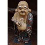 An Oriental stoneware Buddha, 48cm high.