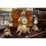 A late 19th century gilt metal and porcelain mounted clock garniture, the clock 42.5cm high, with