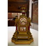 A late 19th century porcelain and gilt metal mantel clock, the back of the case stamped 'PH Mourey