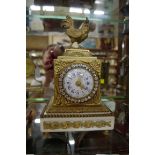 A small Louise XVI style gilt metal and white marble timepiece, 19cm high.