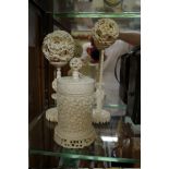 Two Chinese ivory concentric puzzle balls on stands; together with another Chinese carved ivory vase