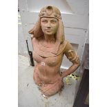 An old red composition stone figure of a semi-nude Egyptian woman, 82cm high, (repairs).